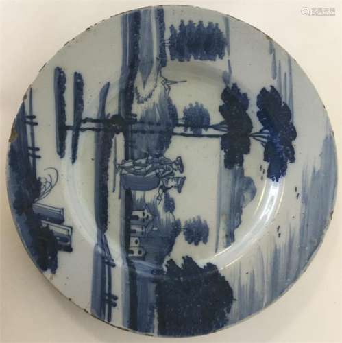 An English Delft blue and white plate painted with figures bef