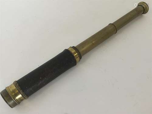 A brass mounted telescope with leather sleeve.