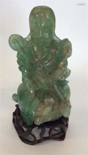 A Chinese green agate figure modelled as a seated