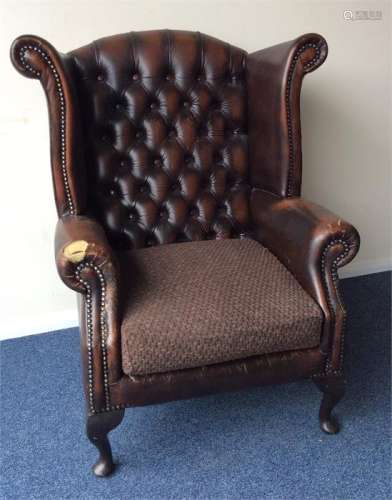 A leather button-back smokers' chair on cabriole l