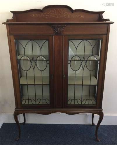 A stylish Edwardian lead-glazed bookcase with stri