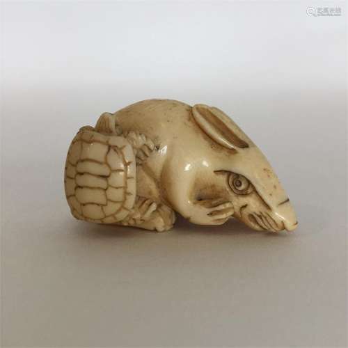 A signed carved ivory netsuke in the form of a rab