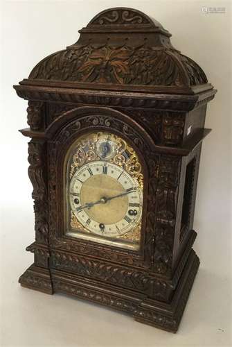 A good quality oak carved bracket clock with gilde