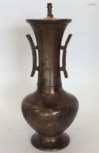 An Oriental bronze lamp decorated with bird and fl