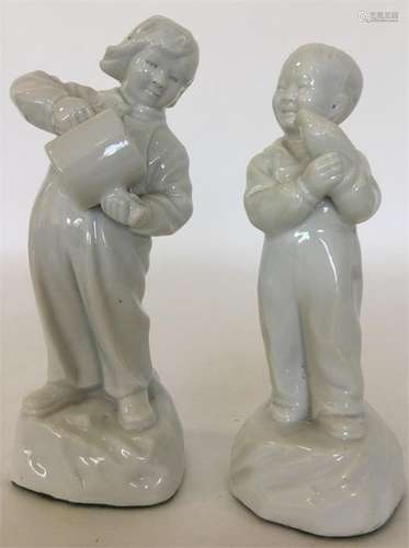 A pair of white-glazed porcelain figures modelled