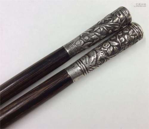 Two Chinese silver topped canes. Est. £50 - £80.