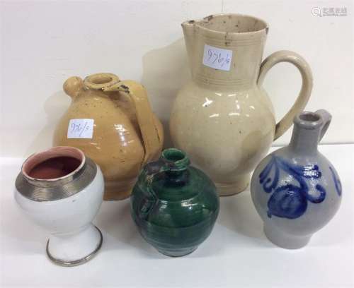 A buff-coloured stoneware oviform jug, measuring approx. 25