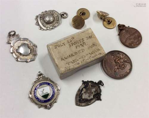 A collection of silver and other boxing medallions