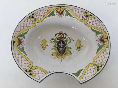 A Faience barber's bowl brightly painted with a cr