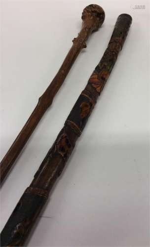 An Eastern tapering walking stick decorated with a