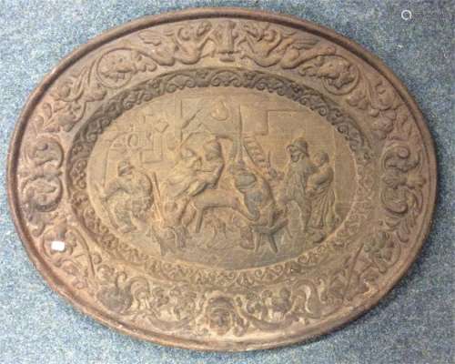 A heavy oval cast iron plaque of a pub scene with