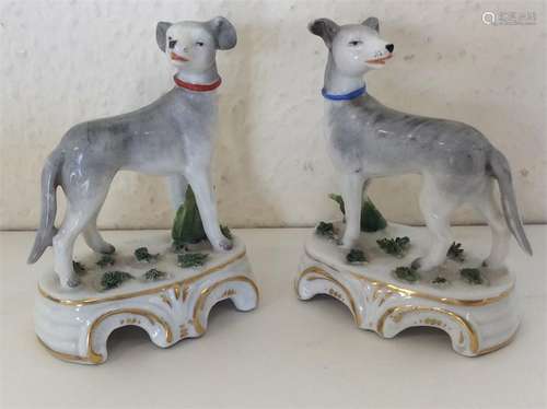 A pair of miniature Staffordshire dogs decorated w