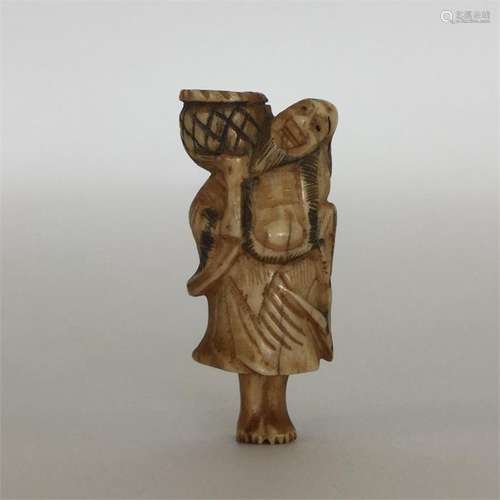 A carved ivory netsuke in the form of a bearded ma