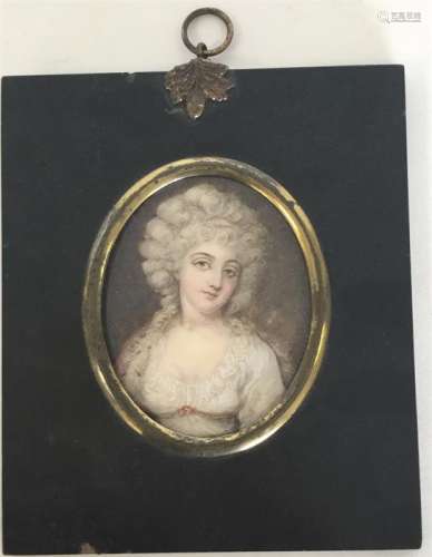 An oval miniature of a lady with wavy hair on a br