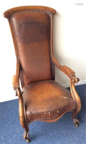A large high-backed mahogany smokers' chair with s