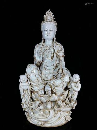 A STATUE OF GUANYIN AND CHILDREN