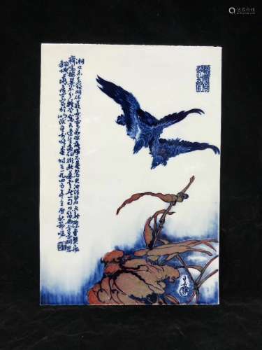 A BLUE AND WHITE PLAQUE OF BIRDS