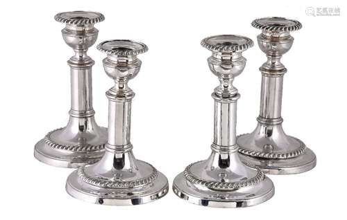 A set of four old Sheffield plate circular telescopic candlesticks, one marked with a hand, circa