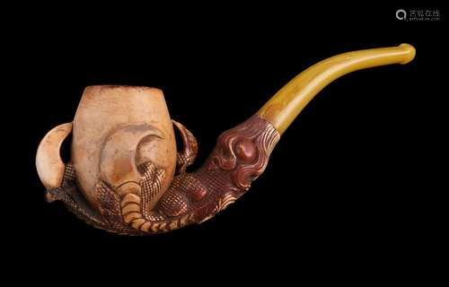 A meerschaum pipe, early 20th century, carved as an eagle's talon holding an egg, with an amber