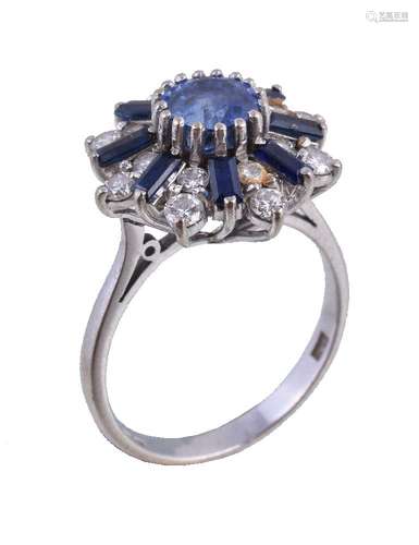 An 18 carat gold sapphire and diamond cluster ring, the central oval cut sapphire claw set within