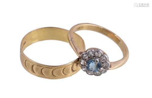 A diamond and aquamarine cluster ring, the circular cut aquamarine surrounded by eight cut diamonds,