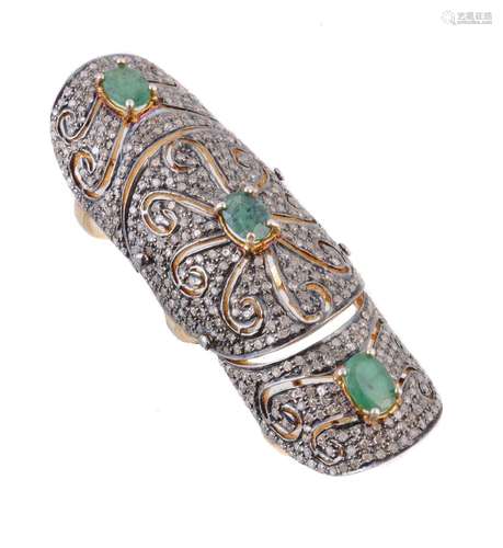 A diamond and emerald articulated dress ring, the pierced panels pavé set with diamond points, and