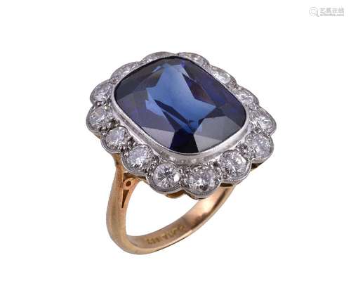 A synthetic sapphire and diamond ring, the cushion cut synthetic sapphire collet set within a