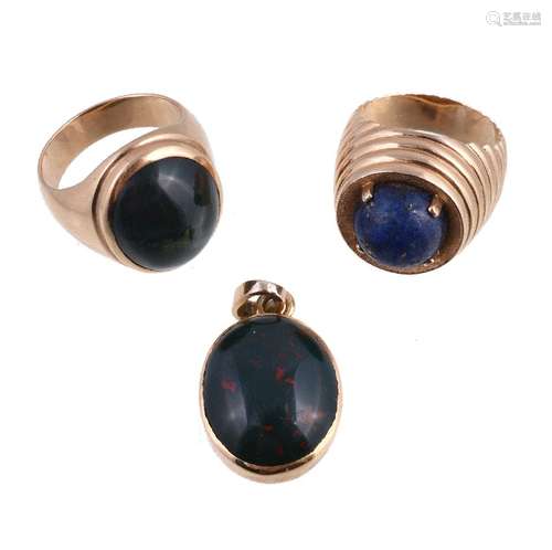 A bloodstone ring, the oval cabochon bloodstone collet set on a wide band, stamped 18K, finger