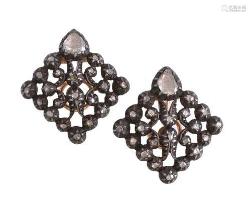 A pair of diamond ear clips, the openwork gold backed silver panels set with rose cut diamonds, with