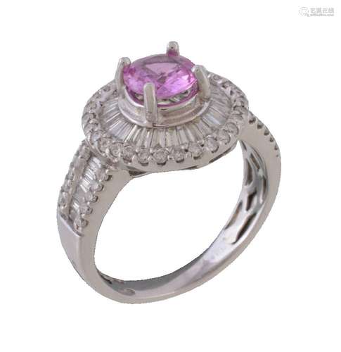 A pink sapphire and diamond cluster ring, the circular cut pink sapphire claw set within a