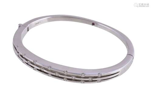 An 18 carat gold diamond bangle, the hinged bangle set with brilliant cut diamonds, approximately