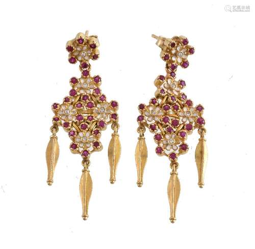 A pair of enamel, ruby and diamond flower head earrings, the white enamel flower head panels set