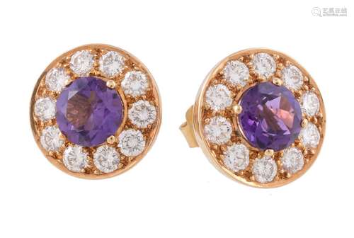 A pair of amethyst and diamond earrings, the circular cut amethyst claw set within a surround of