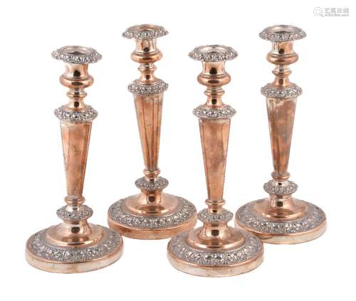 A set of four old Sheffield plate circular candlesticks, circa 1830, 28cm (11in) high