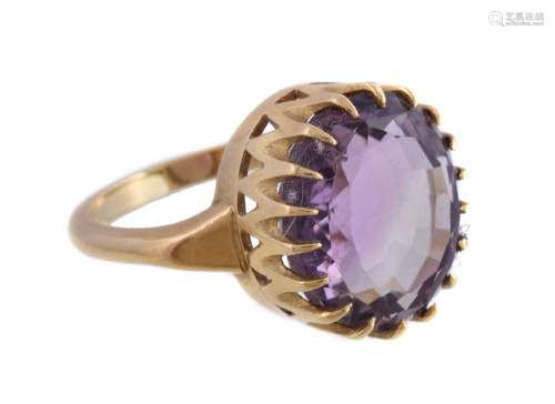 An 18 carat gold amethyst ring, the oval cut amethyst and in a claw setting, stamped 750 with full