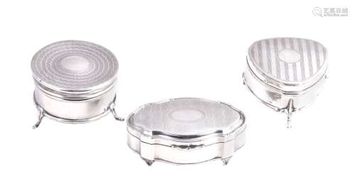 Three various silver dressing table boxes, the first shaped oval by Ollivant & Botsford,