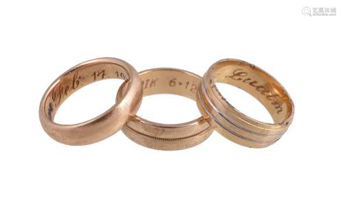 A gold coloured band ring, the shank inscribed Feb 14 1918, 7g; together with a further band ring