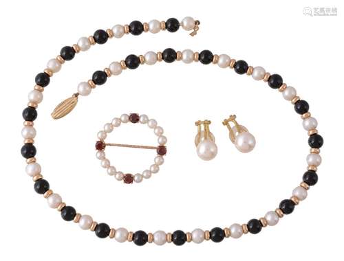 A cultured pearl and garnet brooch, the circlet of cultured pearls with four circular cut garnets,