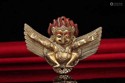 A TIBETAN GILT BRONZE ROC AMULET