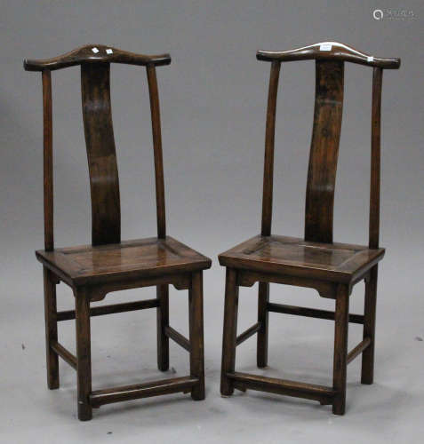 A pair of Chinese softwood side chairs, early 20th century, each arched top rail above a splat