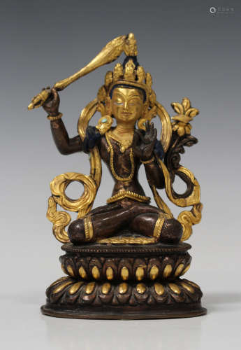 A Sino-Tibetan gilt and brown patinated bronze figure of Manjushri, probably 20th century,