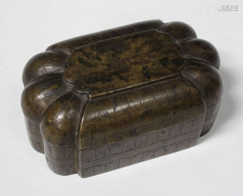 An Indian bronze box and cover, 19th century, of lobed rectangular form, the top engraved with lotus