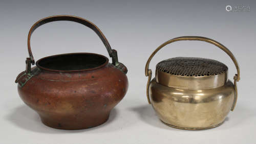 A Chinese polished brass hand warmer, late Qing dynasty, of compressed circular form with pierced