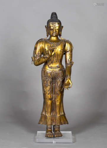 A Chinese gilt bronze figure of Buddha, probably 20th century, modelled standing, wearing a long