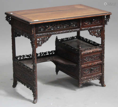 A Chinese hardwood kneehole writing desk, late Qing dynasty, the rectangular panelled top with
