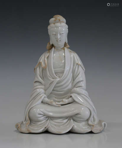 A Chinese blanc-de-Chine figure of Guanyin, Kangxi period, modelled in a seated pose, height 20cm (
