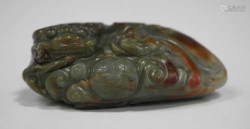 A Chinese jade carving, 20th century, modelled as a recumbent Buddhistic lion and bat, the stone