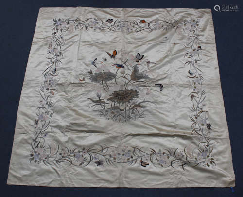 A Chinese cream silk embroidered table cover, early 20th century, worked in coloured threads with