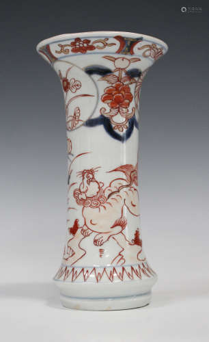 A Japanese Imari porcelain trumpet vase, early 18th century, painted with a Buddhistic lion and