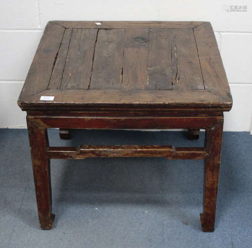 A Chinese softwood table, 19th century, the square panelled top raised on block leg united by